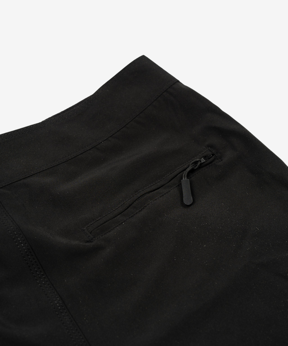 Close-up of the zipped back pocket on Born Maniac men's surfwear board shorts, highlighting the secure storage and functional design.