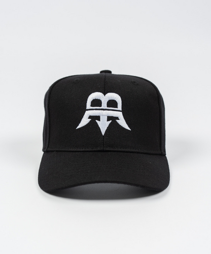 Unisex black snapback hat made from durable woven wool fabric, featuring a bold white Born Maniac logo on the front.